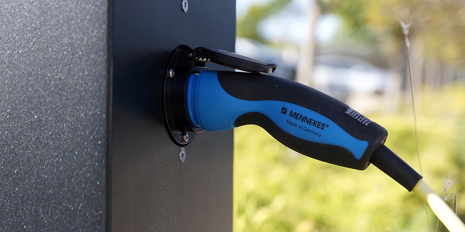 electric vehicle charging station integrated into lighting poles